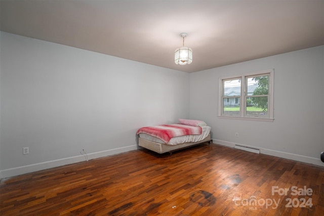 unfurnished bedroom with dark wood-type flooring