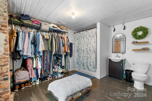 spacious closet with dark hardwood / wood-style flooring and sink