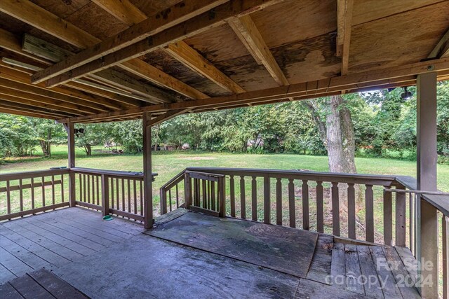 wooden deck featuring a yard