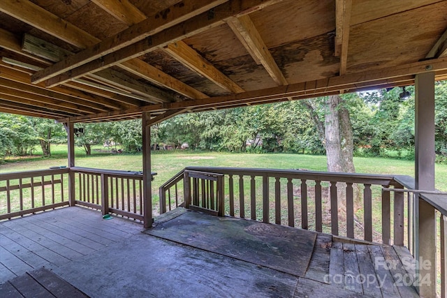 wooden deck featuring a lawn