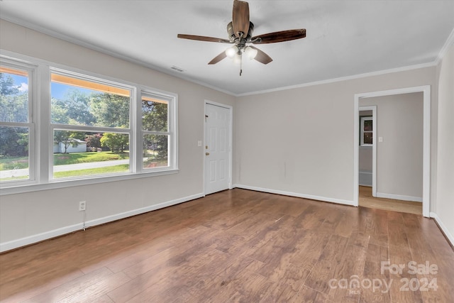 empty room featuring crown molding, ceiling fan, and hardwood / wood-style floors