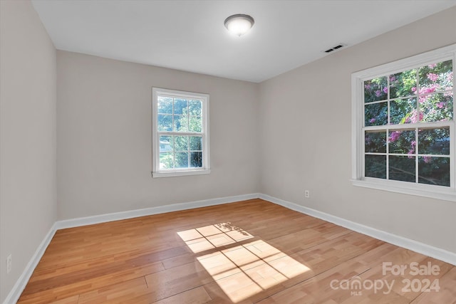 spare room featuring light hardwood / wood-style floors