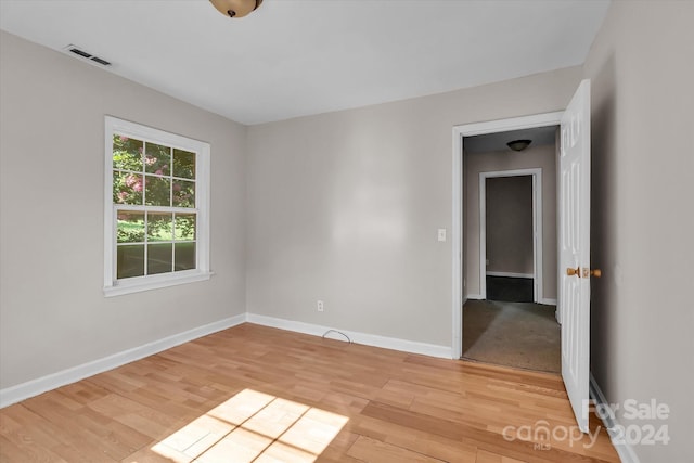 spare room with light wood-type flooring