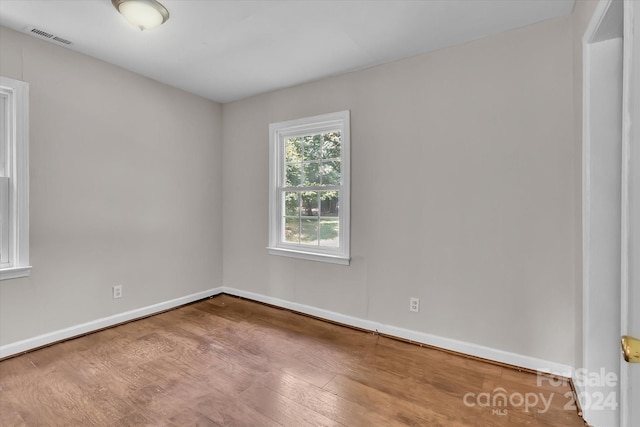 unfurnished room featuring hardwood / wood-style floors