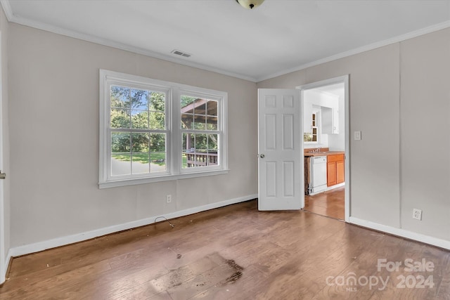 unfurnished bedroom with crown molding and wood-type flooring