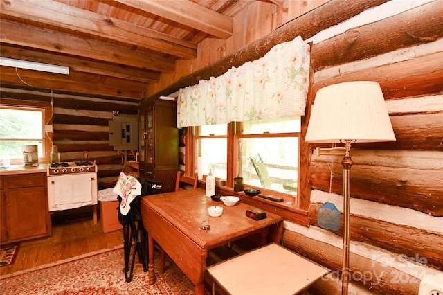 dining area with beam ceiling, wooden ceiling, wood-type flooring, and rustic walls