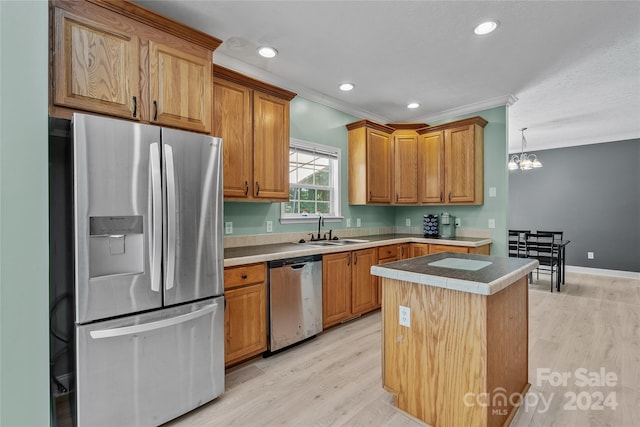 kitchen featuring crown molding, sink, a center island, light hardwood / wood-style floors, and appliances with stainless steel finishes