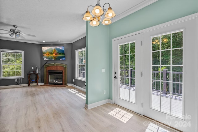 entryway featuring light hardwood / wood-style flooring, a wealth of natural light, and crown molding