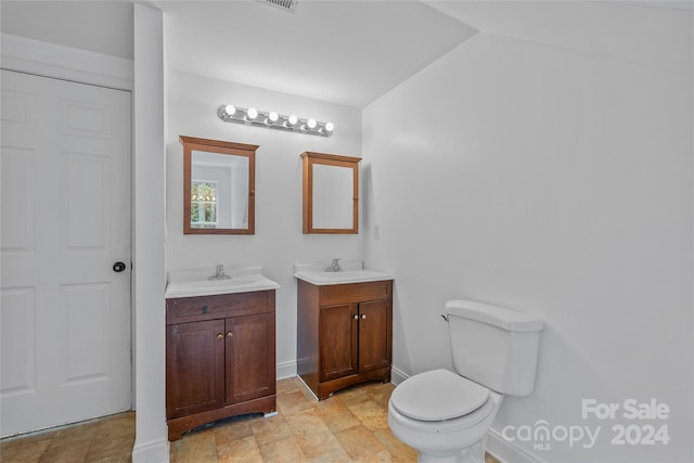 bathroom with vanity, tile patterned flooring, and toilet