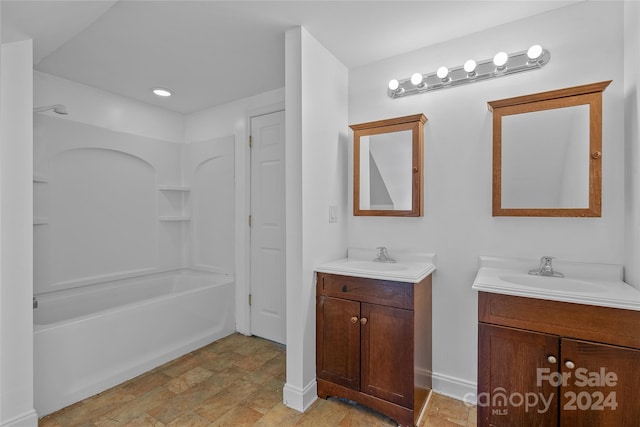 bathroom featuring dual vanity, bathtub / shower combination, and tile patterned flooring