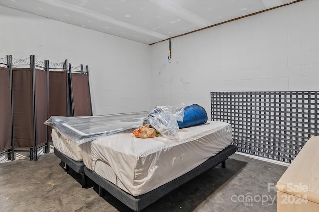 bedroom featuring concrete floors