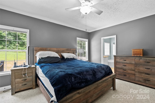 carpeted bedroom with multiple windows, a textured ceiling, and ceiling fan