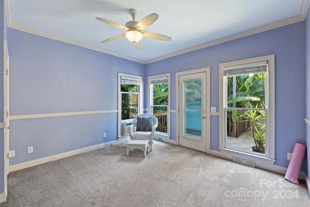 unfurnished room featuring carpet flooring, ornamental molding, and a ceiling fan