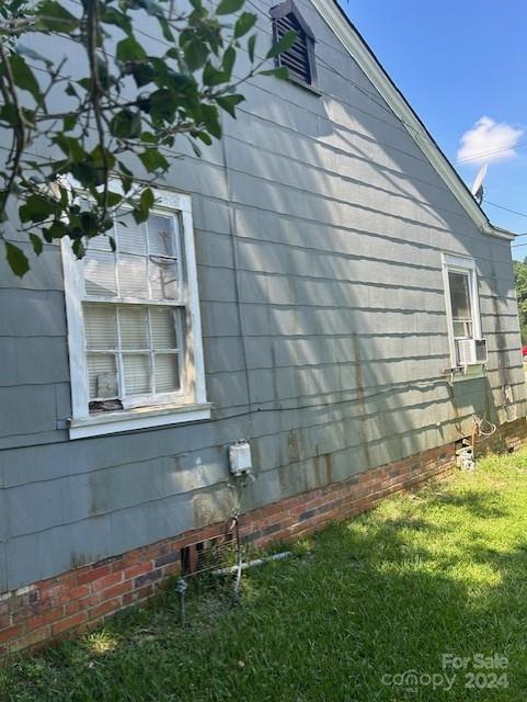 view of side of home featuring a yard