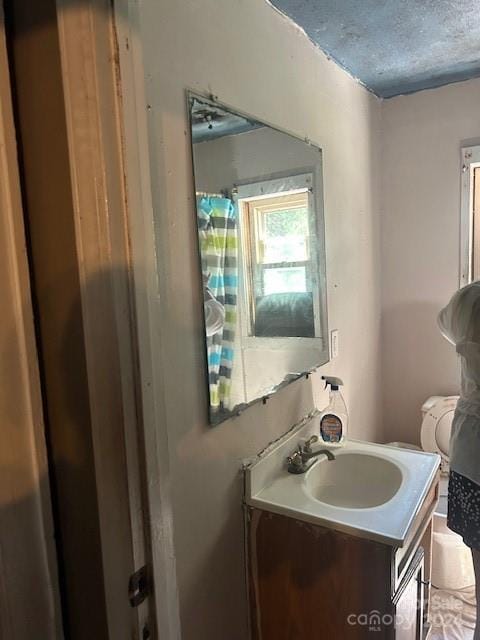 bathroom featuring vanity and a textured ceiling