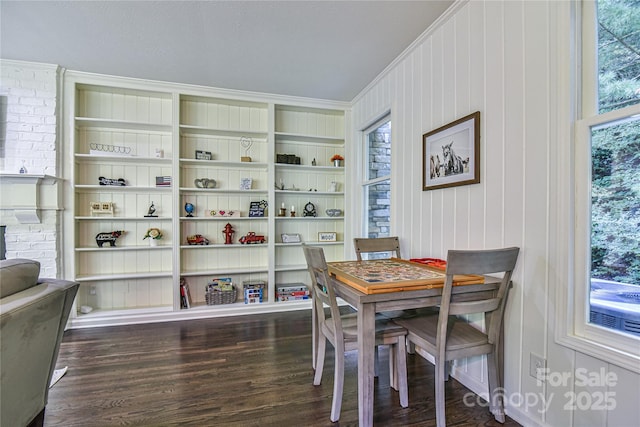 dining room with dark wood-type flooring, plenty of natural light, and built in features