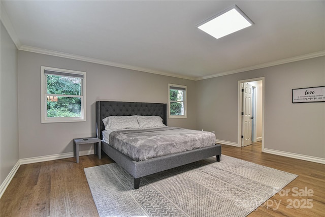 bedroom featuring ornamental molding and wood-type flooring