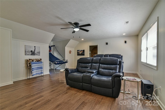 interior space with dark hardwood / wood-style flooring, ceiling fan, lofted ceiling, and a textured ceiling