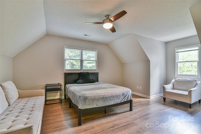 bedroom featuring wood-type flooring, lofted ceiling, and ceiling fan