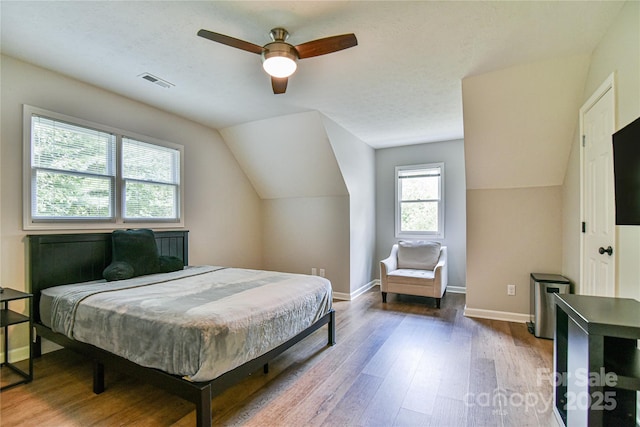 bedroom featuring hardwood / wood-style flooring, ceiling fan, and vaulted ceiling