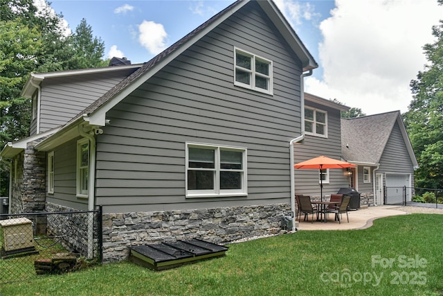 rear view of house with a yard and a patio