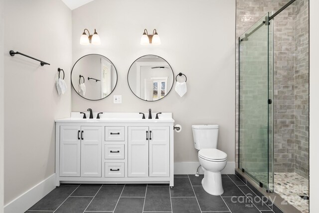 bathroom with tile patterned flooring, vanity, and a shower with shower door