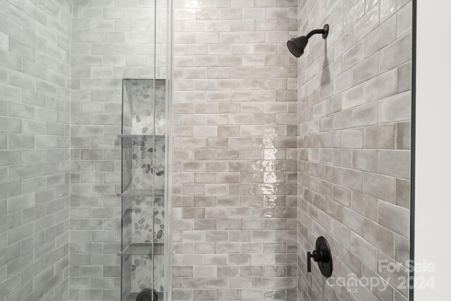 bathroom with tiled shower