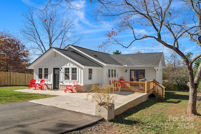 back of property featuring french doors, a yard, and a patio area