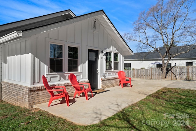 rear view of property with a yard and a patio area