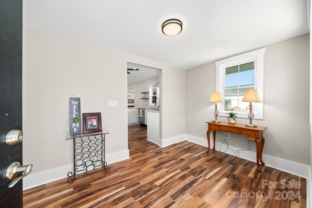 interior space with vaulted ceiling and dark hardwood / wood-style floors