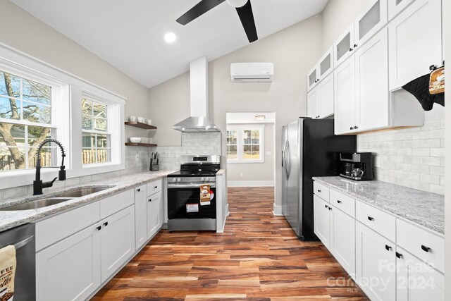 kitchen featuring stainless steel appliances, white cabinetry, wall chimney exhaust hood, and sink