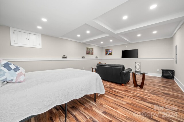 bedroom with beam ceiling, wood-type flooring, and coffered ceiling