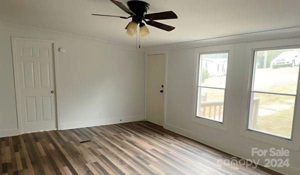 empty room with wood-type flooring and ceiling fan