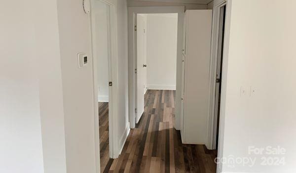 hall with dark hardwood / wood-style flooring