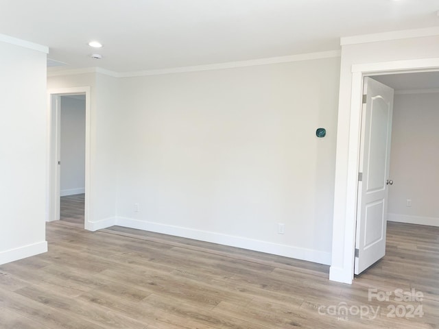 unfurnished room with light hardwood / wood-style floors and ornamental molding