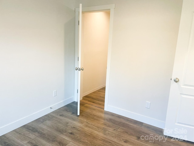 spare room featuring wood-type flooring