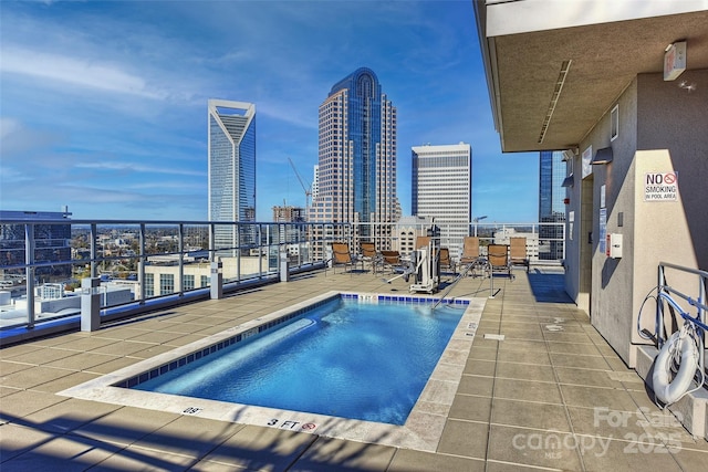 view of pool with a pool and a city view