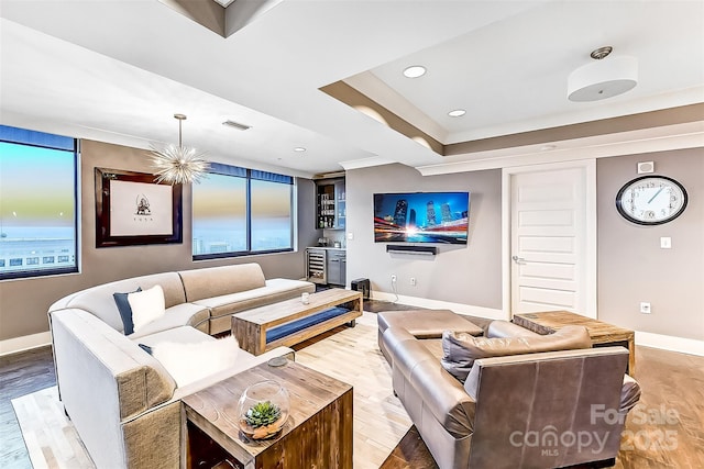 living room featuring recessed lighting, wood finished floors, visible vents, and baseboards