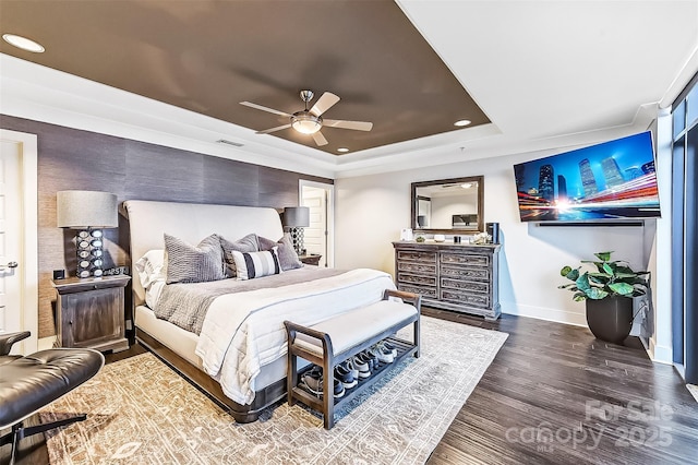 bedroom with recessed lighting, visible vents, baseboards, a tray ceiling, and dark wood finished floors