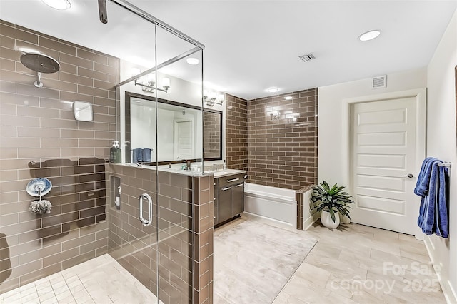 full bathroom featuring vanity, a shower stall, and visible vents