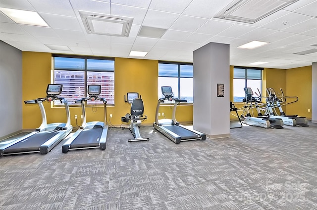 workout area featuring carpet floors, visible vents, and baseboards