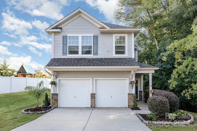 craftsman-style home featuring a garage and a front yard