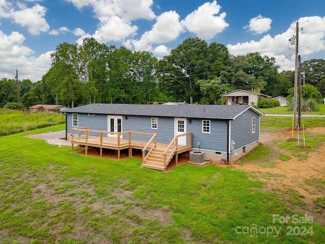 back of property featuring french doors, a wooden deck, central AC, and a lawn