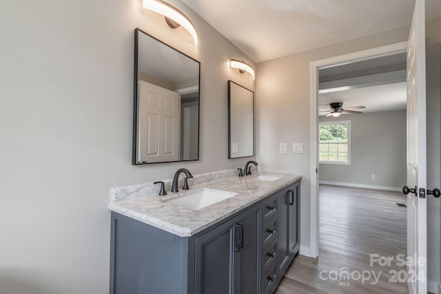 bathroom with ceiling fan, vanity, and wood-type flooring