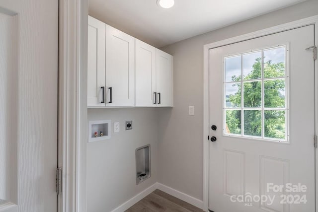 washroom featuring cabinets, washer hookup, dark wood-type flooring, and hookup for an electric dryer