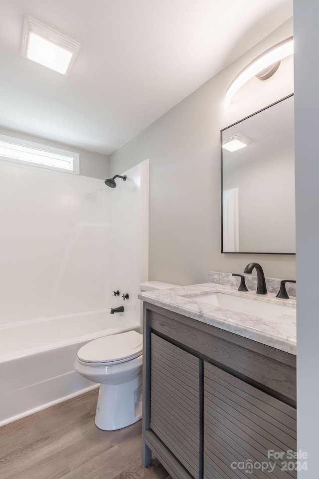 full bathroom featuring vanity, wood-type flooring, tub / shower combination, and toilet