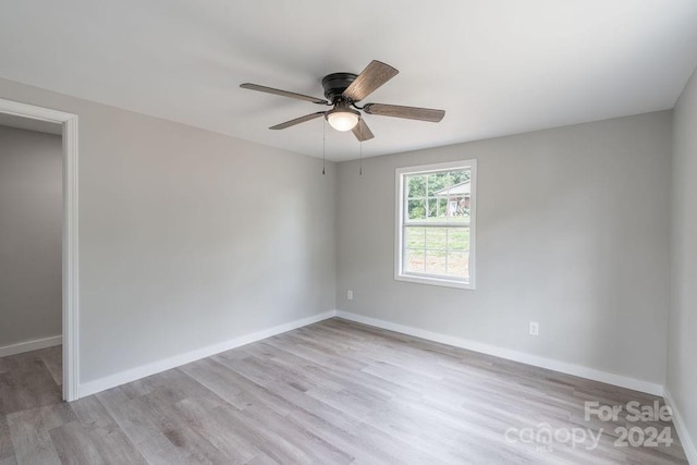 spare room with ceiling fan and light hardwood / wood-style floors