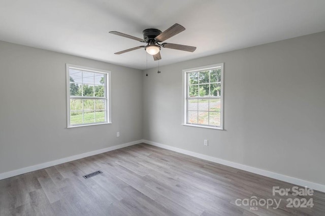 unfurnished room with ceiling fan, light hardwood / wood-style flooring, and a wealth of natural light