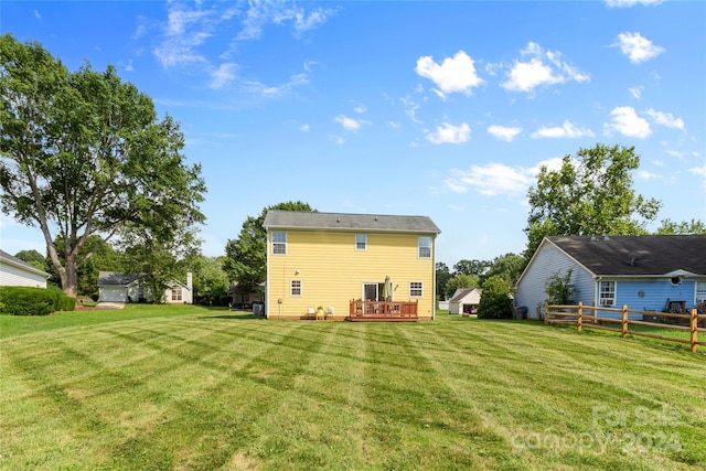 back of house with a yard and a deck