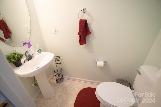 bathroom with toilet and tile patterned floors